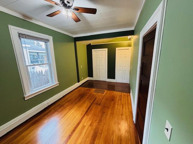 1358 Rte 44, Pleasant Valley, NY 12569 - unfurnished room with baseboards, a ceiling fan, wood finished floors, and crown molding