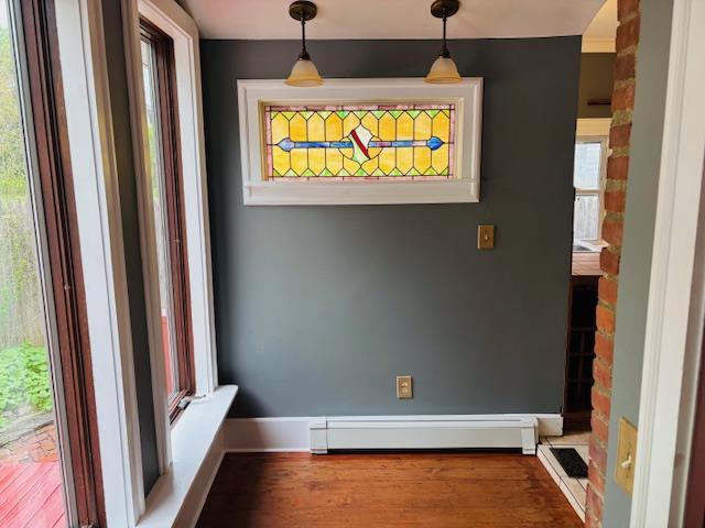1358 Rte 44, Pleasant Valley, NY 12569 - unfurnished dining area with a baseboard heating unit, wood finished floors, and baseboards