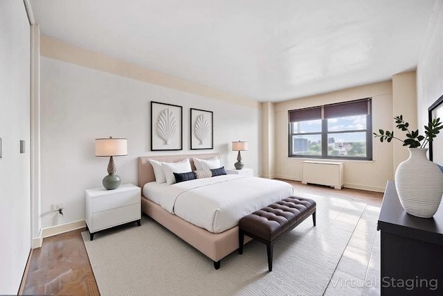 bedroom with radiator and baseboards