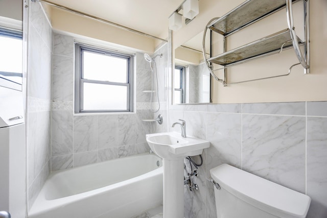 full bathroom featuring tile walls, toilet, and shower / tub combination