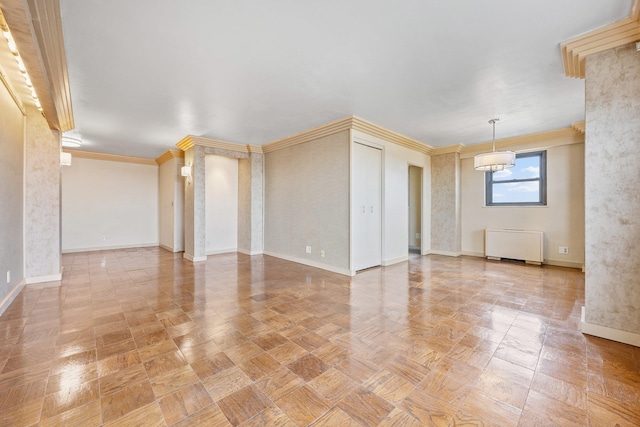 empty room with radiator heating unit, ornamental molding, and baseboards