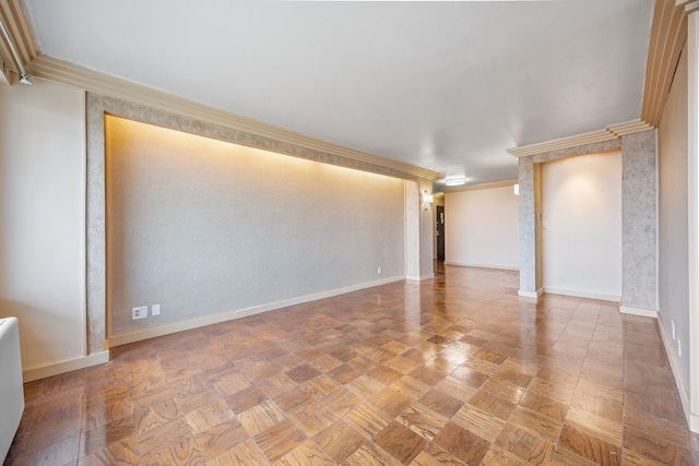 unfurnished living room featuring baseboards and crown molding