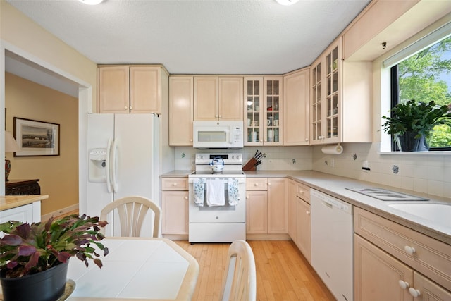 41 Heritage Hills Dr Unit A, Somers, NY 10589 - kitchen featuring white appliances, light brown cabinetry, light wood finished floors, light countertops, and a textured ceiling