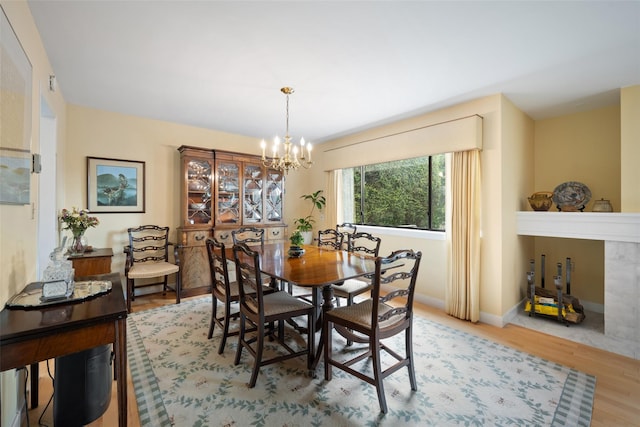 41 Heritage Hills Dr Unit A, Somers, NY 10589 - dining space featuring a chandelier, wood finished floors, and baseboards