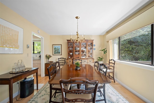 41 Heritage Hills Dr Unit A, Somers, NY 10589 - dining area featuring light wood-style floors, baseboards, and a chandelier