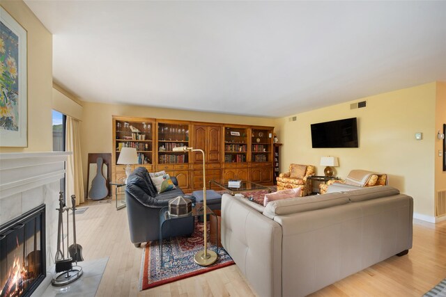 41 Heritage Hills Dr Unit A, Somers, NY 10589 - living room with a warm lit fireplace and light wood finished floors