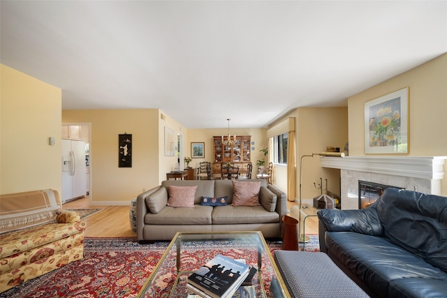 41 Heritage Hills Dr Unit A, Somers, NY 10589 - living area with light wood-style floors, a tile fireplace, baseboards, and a chandelier