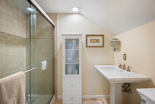 41 Heritage Hills Dr Unit A, Somers, NY 10589 - bathroom with a shower stall, a textured ceiling, lofted ceiling, toilet, and a sink