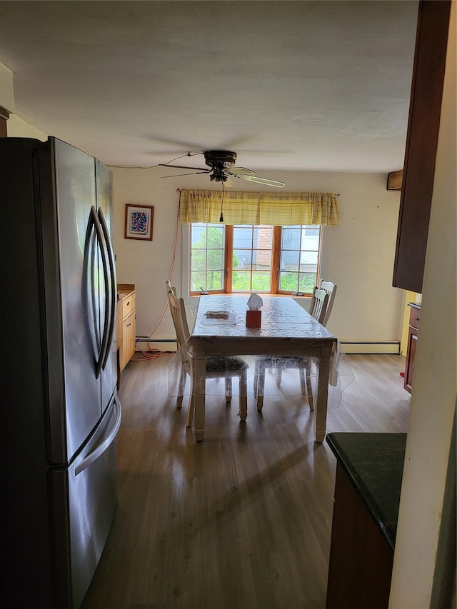 76 Moriches Rd, Lake Grove, NY 11755 - dining room featuring baseboard heating, dark wood finished floors, and a ceiling fan