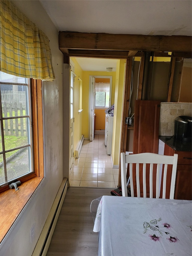 76 Moriches Rd, Lake Grove, NY 11755 - dining room featuring a baseboard radiator, separate washer and dryer, and light wood-style flooring