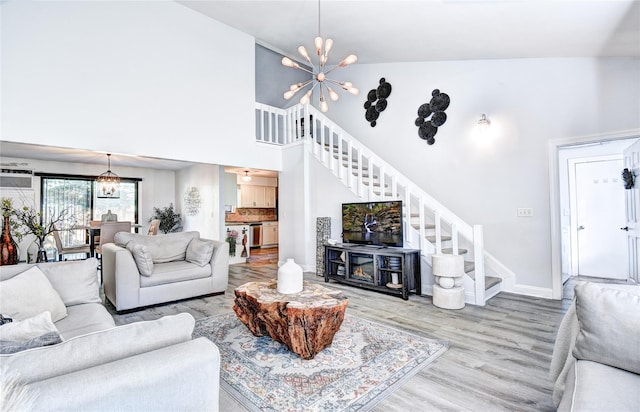 10 Butler Dr, Goshen, NY 10924 - living area with stairs, wood finished floors, a chandelier, baseboards, and a high ceiling