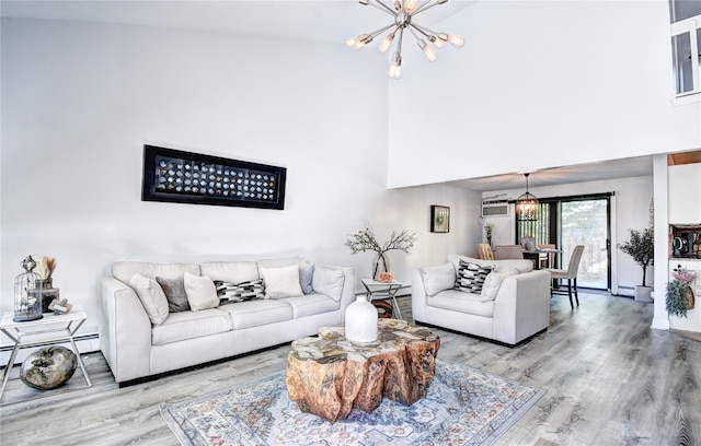 10 Butler Dr, Goshen, NY 10924 - living area featuring a chandelier, wood finished floors, a towering ceiling, and a wall mounted AC