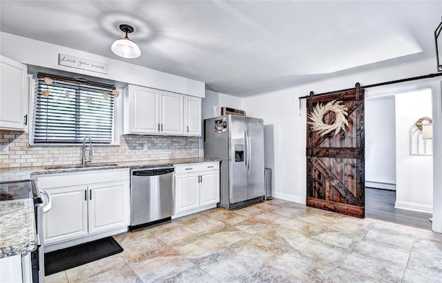 10 Butler Dr, Goshen, NY 10924 - kitchen featuring appliances with stainless steel finishes, a sink, a barn door, a baseboard heating unit, and backsplash