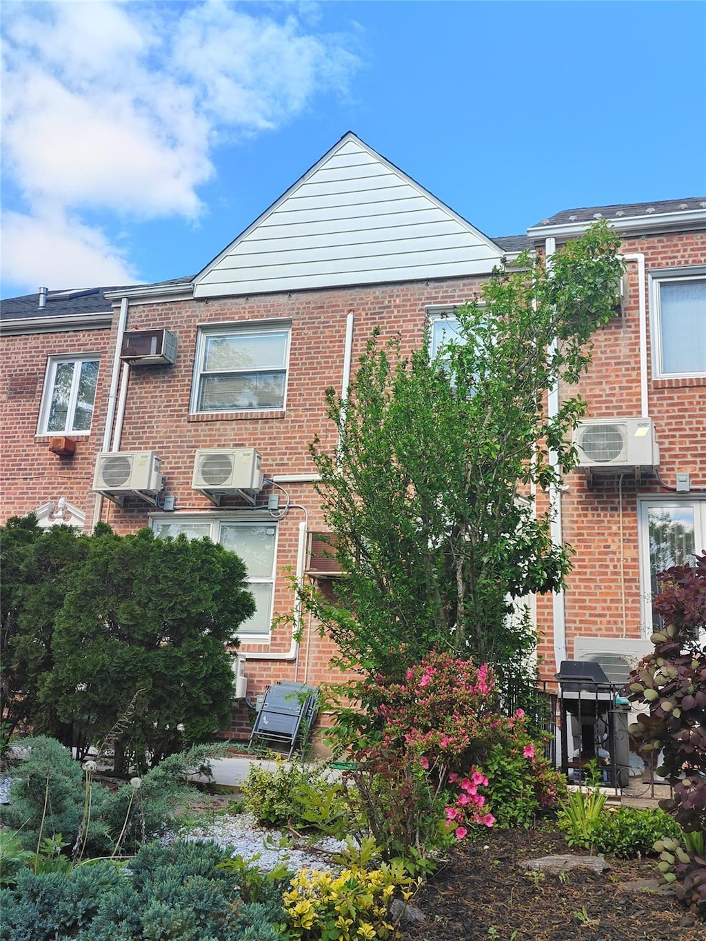 141-49 72nd Cres, Kew Garden Hills, NY 11367 - view of front facade with brick siding and ac unit