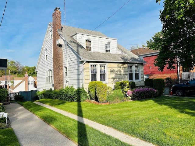 3611 204th St, Bayside, NY 11361 - view of front facade with a chimney, roof with shingles, and a front lawn