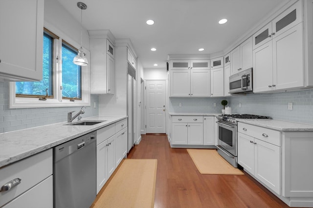 1 Wensley Dr, Great Neck, NY 11021 - kitchen with stainless steel appliances, a sink, wood finished floors, white cabinetry, and recessed lighting