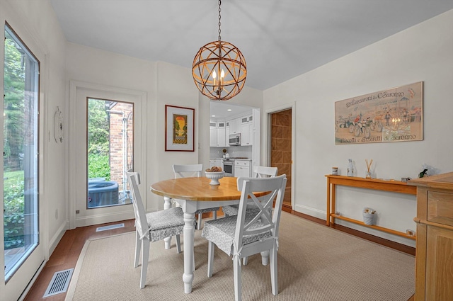 1 Wensley Dr, Great Neck, NY 11021 - dining space featuring a chandelier, wood finished floors, and baseboards