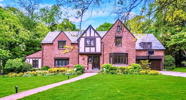 1 Wensley Dr, Great Neck, NY 11021 - english style home featuring brick siding, a front lawn, and driveway