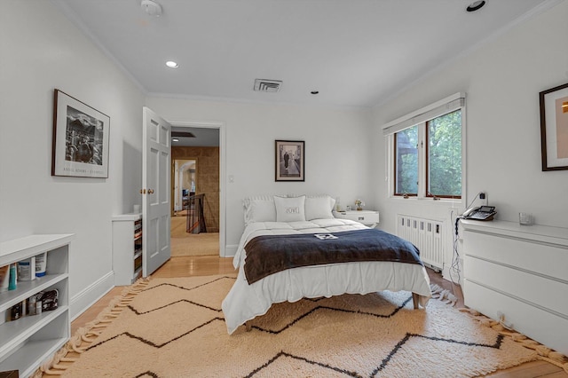 1 Wensley Dr, Great Neck, NY 11021 - bedroom with radiator heating unit, crown molding, light wood finished floors, recessed lighting, and baseboards