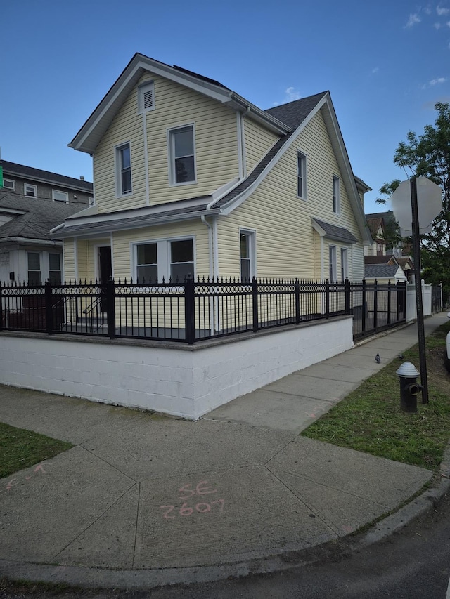 12702 97th Ave, Richmond Hill S, NY 11419 - view of property exterior featuring a fenced front yard