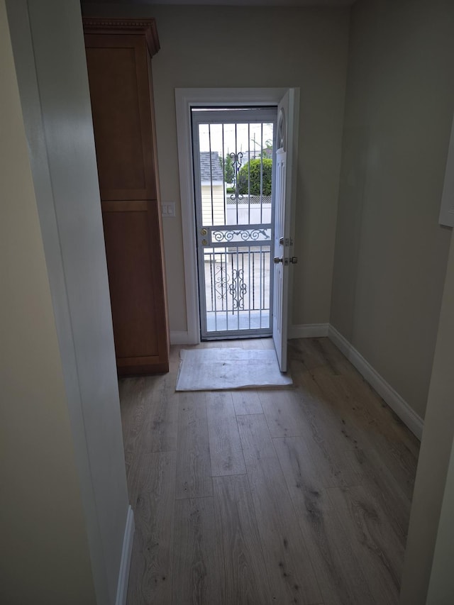 12702 97th Ave, Richmond Hill S, NY 11419 - doorway featuring baseboards and light wood-style flooring