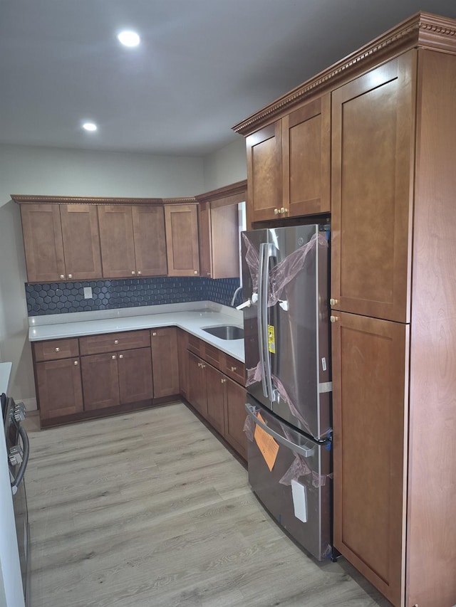 12702 97th Ave, Richmond Hill S, NY 11419 - kitchen featuring freestanding refrigerator, a sink, light wood-style floors, decorative backsplash, and stove