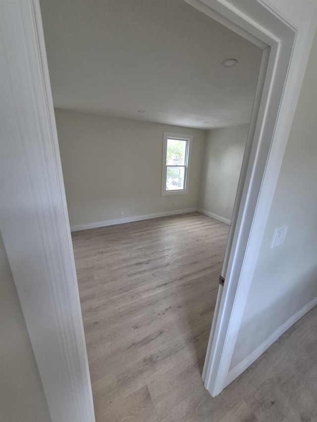 12702 97th Ave, Richmond Hill S, NY 11419 - empty room with wood finished floors and baseboards