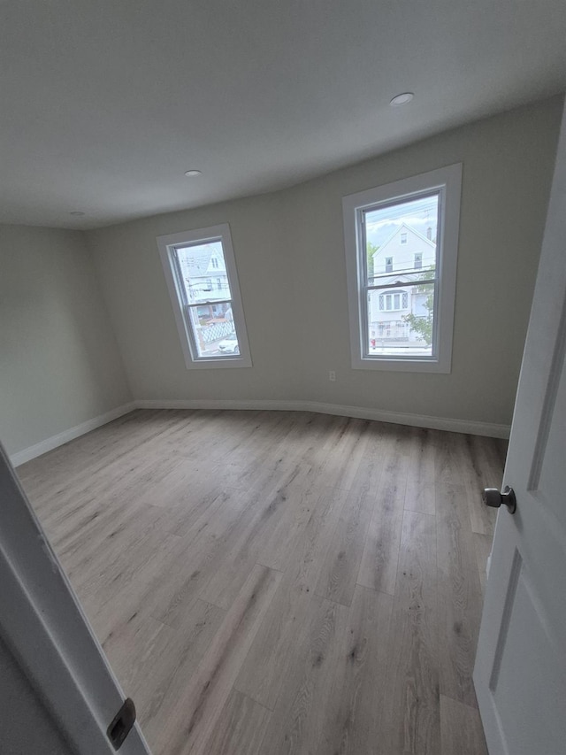 12702 97th Ave, Richmond Hill S, NY 11419 - unfurnished room with healthy amount of natural light, wood finished floors, baseboards, and recessed lighting