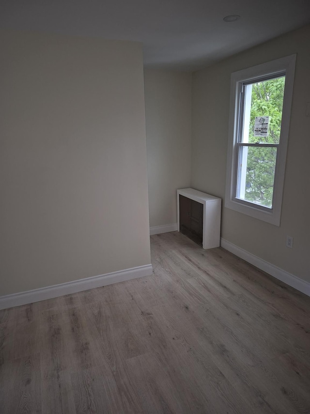 12702 97th Ave, Richmond Hill S, NY 11419 - unfurnished room with light wood finished floors and baseboards
