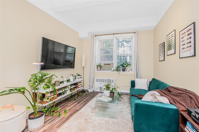 living room with wood finished floors and cooling unit