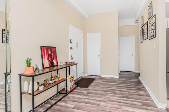hall with wood finished floors and baseboards