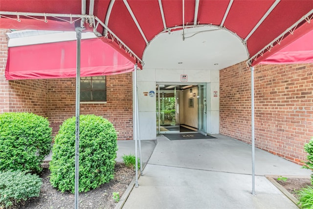 property entrance with brick siding
