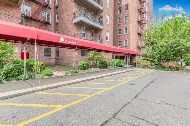 view of apartment building / complex featuring covered parking