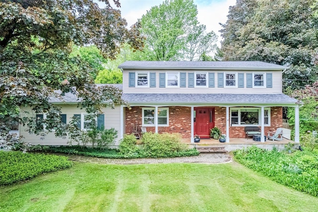24 Overhill Ln, Warwick, NY 10990 - traditional-style home with covered porch, a front yard, brick siding, and roof with shingles