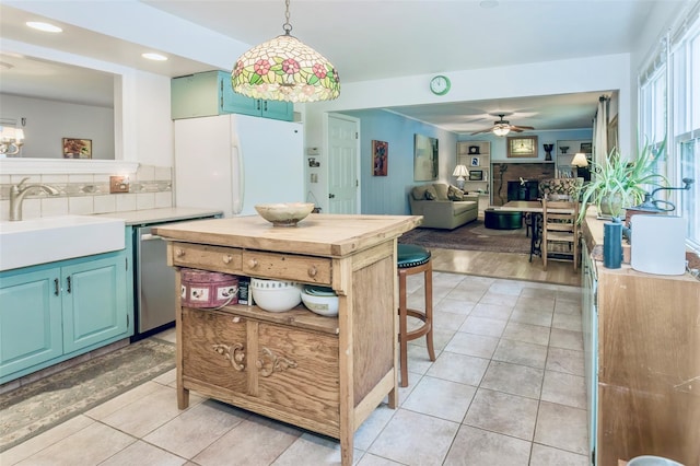 24 Overhill Ln, Warwick, NY 10990 - kitchen featuring a sink, a ceiling fan, freestanding refrigerator, stainless steel dishwasher, and light countertops