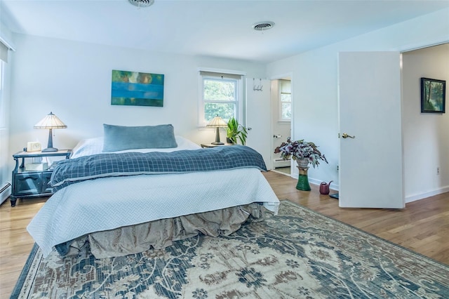 24 Overhill Ln, Warwick, NY 10990 - bedroom with wood finished floors, baseboards, and baseboard heating