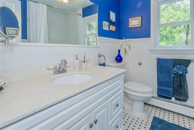 24 Overhill Ln, Warwick, NY 10990 - bathroom featuring a wainscoted wall, toilet, baseboard heating, vanity, and tile patterned flooring