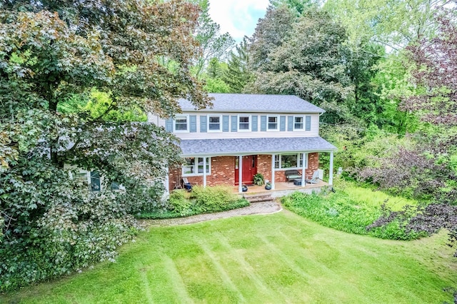 24 Overhill Ln, Warwick, NY 10990 - traditional-style house with covered porch, a front yard, brick siding, and a shingled roof