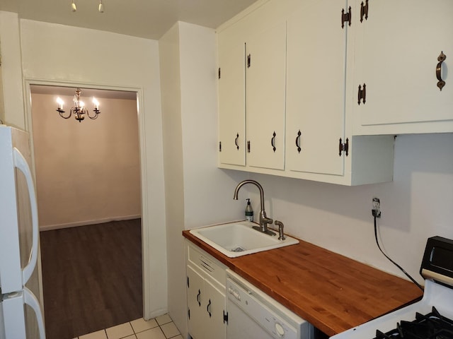 61-35 98th St Unit 4J, Rego Park, NY 11374 - kitchen with a sink, white appliances, a chandelier, butcher block counters, and white cabinetry