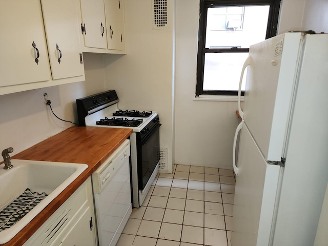 61-35 98th St Unit 4J, Rego Park, NY 11374 - kitchen featuring white appliances, a sink, healthy amount of natural light, and white cabinets