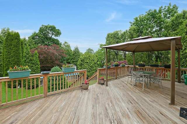 wooden deck with a gazebo and outdoor dining space