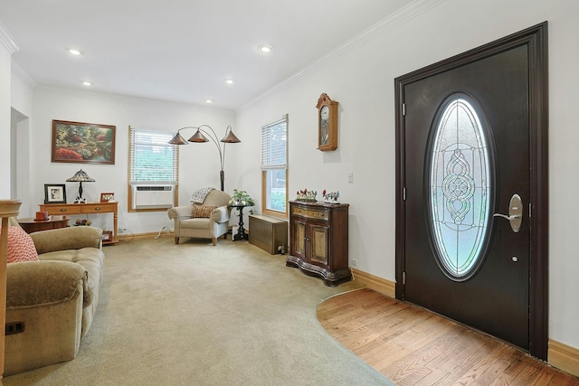 foyer featuring crown molding, baseboards, recessed lighting, and light wood-type flooring