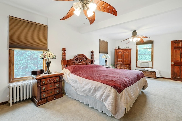 carpeted bedroom featuring radiator heating unit, baseboards, a ceiling fan, cooling unit, and beam ceiling