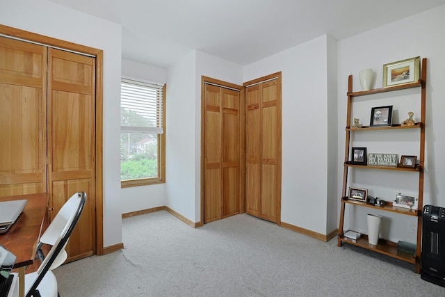 home office with light carpet and baseboards