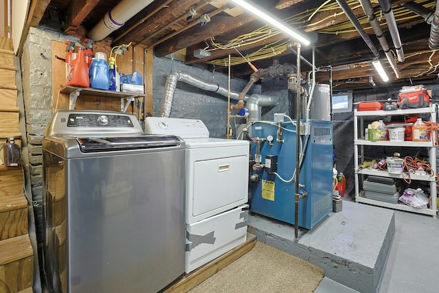 unfinished below grade area featuring washer and clothes dryer and heating unit