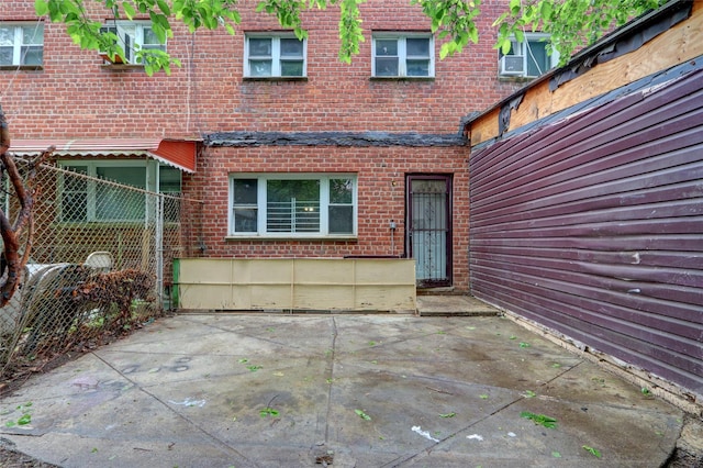 122-52 Springfield Blvd, Springfield Gardens, NY 11413 - view of exterior entry featuring brick siding and a patio area