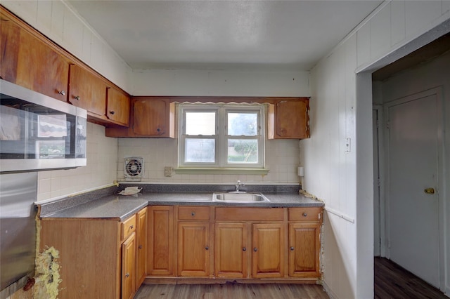 122-52 Springfield Blvd, Springfield Gardens, NY 11413 - kitchen with a sink, stainless steel microwave, tasteful backsplash, and light wood-style flooring
