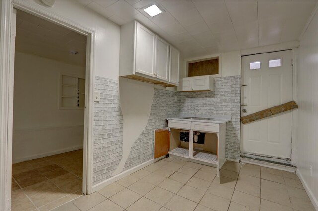 122-52 Springfield Blvd, Springfield Gardens, NY 11413 - kitchen with white cabinetry, light tile patterned floors, light countertops, and baseboards