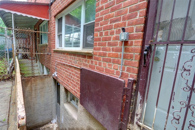 122-52 Springfield Blvd, Springfield Gardens, NY 11413 - doorway to property featuring brick siding