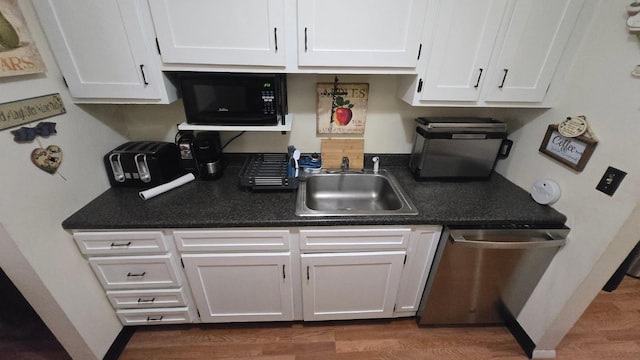 1115 Cherry Hill Dr, Poughkeepsie, NY 12603 - kitchen with black microwave, stainless steel dishwasher, a sink, and white cabinets